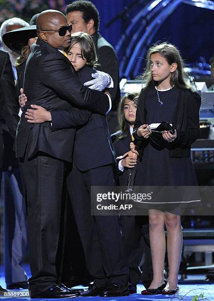 Randy Jackson embraces Michael Jackson's oldest son Prince Michael I with daughter Paris Jackson looking on during the memorial service for Michael...