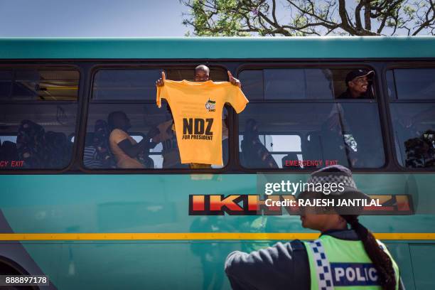 Supporter of candidate for South Africa's ruling African National Congress party leadership Nkosazana Dlamini-Zuma holds a t-shirt as he arrives with...