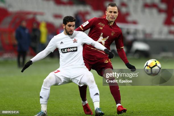 Fyodor Kudryashov of FC Rubin Kazan vies for the ball with Maksim Kazankov SKA Khabarovsk during the Russian Premier League match between FC Rubin...