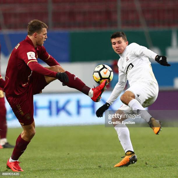 Maksim Kanunnikov of FC Rubin Kazan vies for the ball with Nikolay Kalinsky SKA Khabarovsk during the Russian Premier League match between FC Rubin...