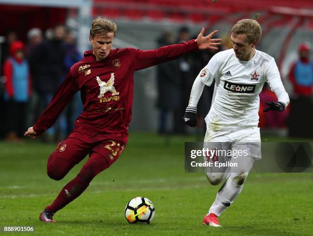 Moritz Bauer of FC Rubin Kazan vies for the ball with Alksandr Maksimenko SKA Khabarovsk during the Russian Premier League match between FC Rubin...