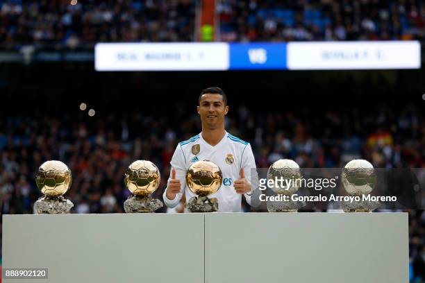 Cristiano Ronaldo of Real Madrid CF poses with his five Golden Ball trophies prior to start the La Liga match between Real Madrid CF and Sevilla FC...