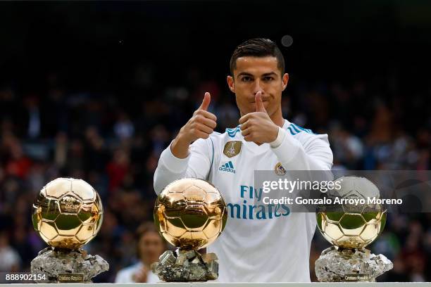 Cristiano Ronaldo of Real Madrid CF poses with his five Golden Ball trophies prior to start the La Liga match between Real Madrid CF and Sevilla FC...