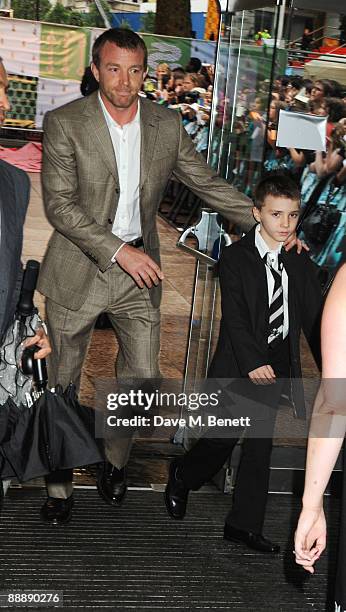 Guy Ritchie and his son Rocco arrive at the World Premiere of 'Harry Potter And The Half-Blood Prince' at Odeon Leicester Square on July 7, 2009 in...