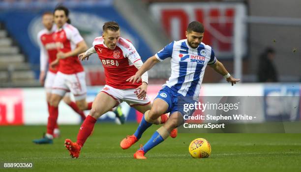 Wigan Athletic's Sam Morsy holds off the challenge from Fleetwood Town's George Glendon during the Sky Bet League One match between Wigan Athletic...