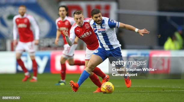 Wigan Athletic's Sam Morsy holds off the challenge from Fleetwood Town's George Glendon during the Sky Bet League One match between Wigan Athletic...