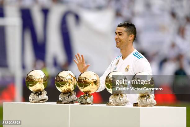 Cristiano Ronaldo of Real Madrid poses with his five Ballon d'Or trophies before the La Liga match between Real Madrid and Sevilla at Estadio...