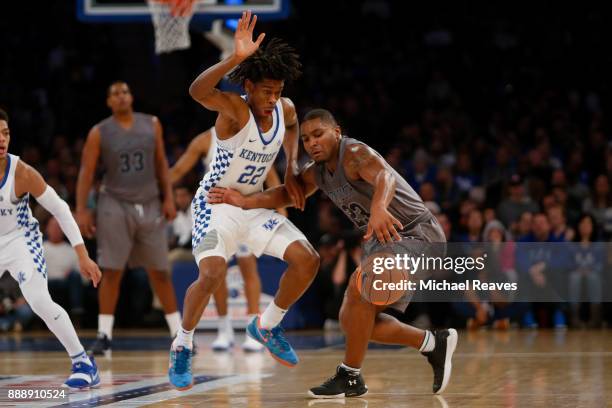 Shai Gilgeous-Alexander of the Kentucky Wildcats knocks the ball loose from Austin Tilghman of the Monmouth Hawks during the first half at Madison...