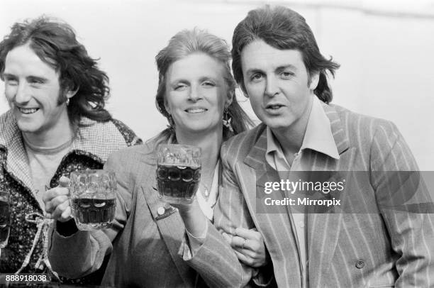 Paul McCartney and his wife Linda of pop group Wings enjoy a pint of ale as they make a film to promote their new single 'With A Little Luck' in...