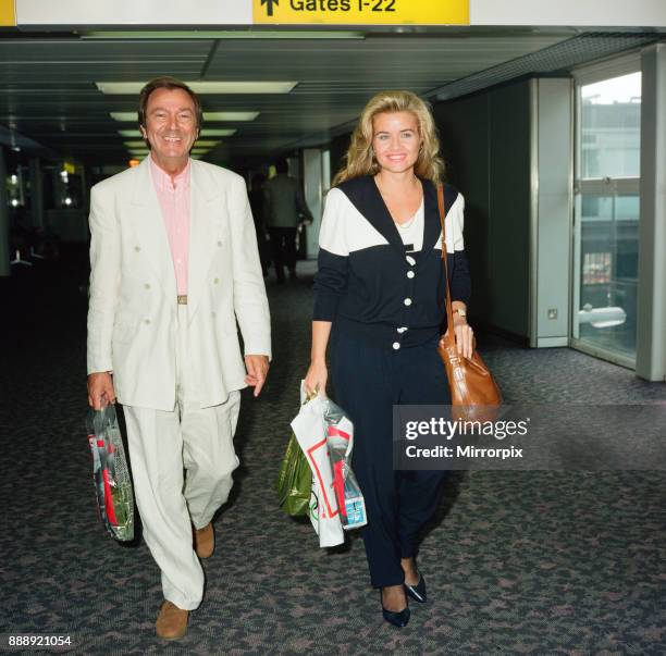 Des O'Connor and girlfriend Jodie Brooke Wilson and Heathrow Airport, 30th August 1992.