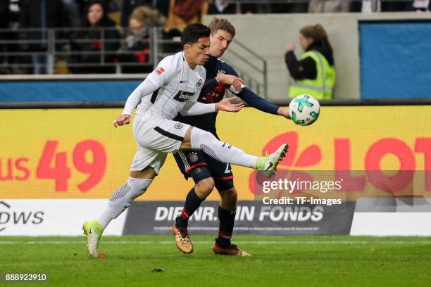Carlos Joel Salcedo Hernandez of Frankfurt and Thomas Mueller of Muenchen battle for the ball during the Bundesliga match between Eintracht Frankfurt...