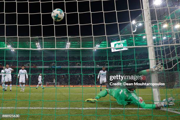 Christoph Kramer of Moenchengladbach scores a goal past goalkeeper Ralf Faehrmann of Schalke to make it 1:0 during the Bundesliga match between...