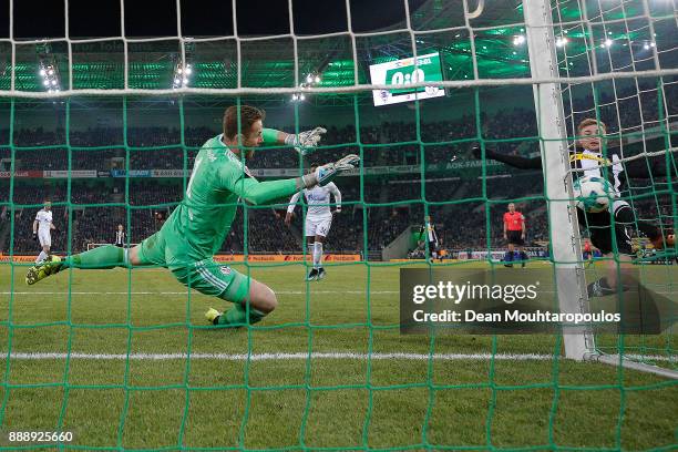 Christoph Kramer of Moenchengladbach scores a goal past goalkeeper Ralf Faehrmann of Schalke to make it 1:0 during the Bundesliga match between...