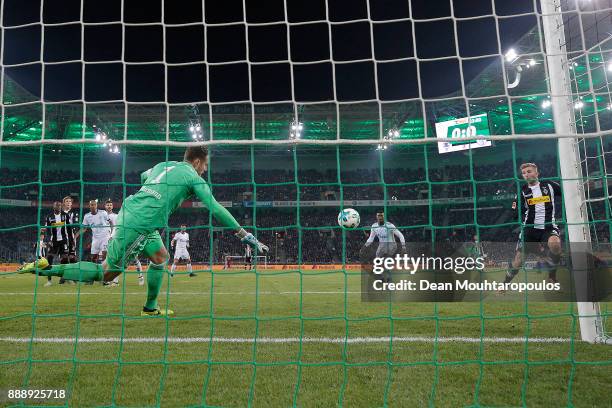 Christoph Kramer of Moenchengladbach scores a goal past goalkeeper Ralf Faehrmann of Schalke to make it 1:0 during the Bundesliga match between...