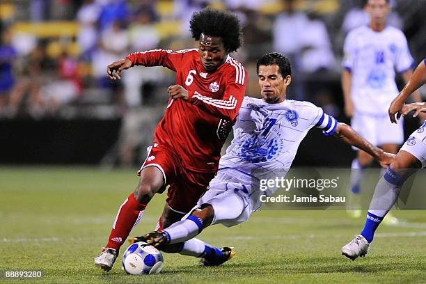 Julian de Guzman of Canada is taken down by Ramon Sanchez of El Salvador at Crew Stadium on July 7, 2009 in Columbus, Ohio.