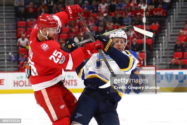 Mike Green of the Detroit Red Wings lays a first period hit on Carl Gunnarsson of the St. Louis Blues at Little Caesars Arena on December 9, 2017 in...