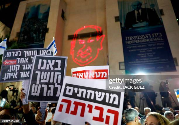 Israelis take part in a demonstration under the name "March of Shame" to protest against government corruption and Prime Minister Benjamin Netanyahu...