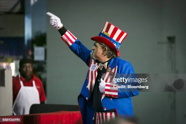 An attendee wears an Uncle Sam costume during a campaign rally with U.S. President Donald Trump in Pensacola, Florida, U.S., on Friday, Dec. 8, 2017....