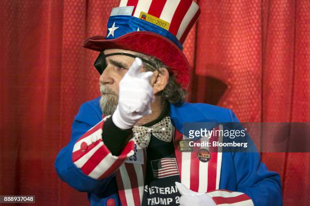 An attendee wears an Uncle Sam costume during a campaign rally with U.S. President Donald Trump in Pensacola, Florida, U.S., on Friday, Dec. 8, 2017....