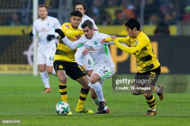 Mahmound Dahoud of Dortmund, Fin Bartels of Bremen and Shinji Kagawa of Dortmund battle for the ball during the Bundesliga match between Borussia...