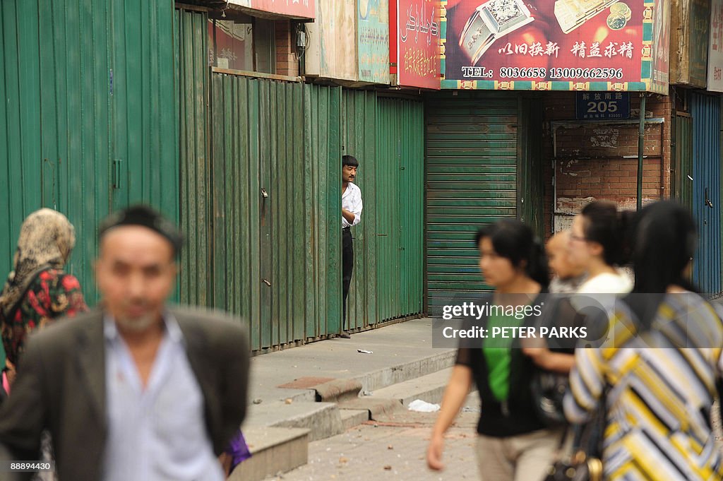 A Muslim man looks out from his boarded