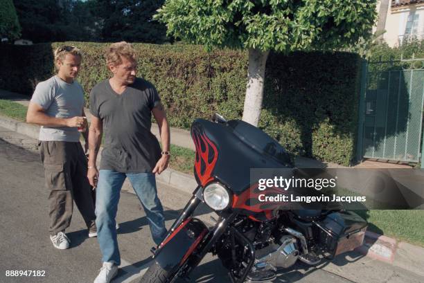 French singer Johnny Hallyday prepares his concert 'Allume le feu' in September at Stade de France, near Paris. Here, with his son, singer and...