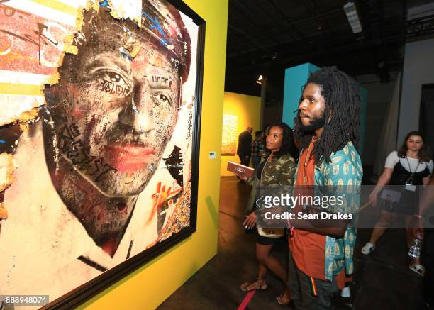 Jamaican recording artist Chronixx views art on exhibit at No Commission Art and Music Experience hosted by The Dean Collection and Bacardi during...