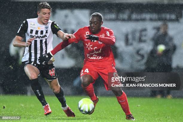 Angers' French forward Baptiste Guillaume vies with Montpellier's French defender Jerome Roussillon during the French L1 Football match between...