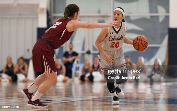 Honoka Ikematsu of the Robert Morris Colonials brings the ball up court against Sammy Stipa of the Lafayette Leopards in the second half during the...