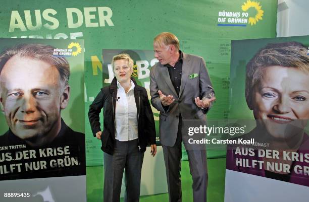 German Greens party lead elections candidates Juergen Trittin and Renate Kuenast pose next to a sign showing the campaign for the next federal...