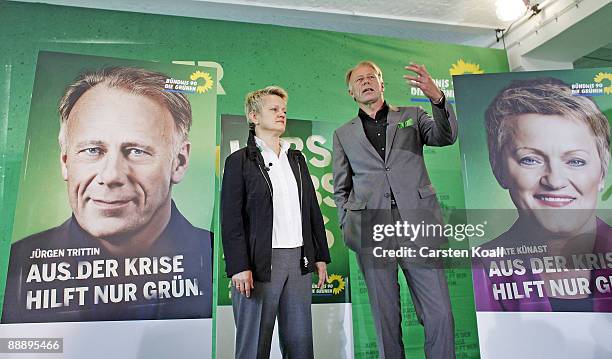 German Greens party lead elections candidates Juergen Trittin and Renate Kuenast pose next to a sign showing the campaign for the next federal...