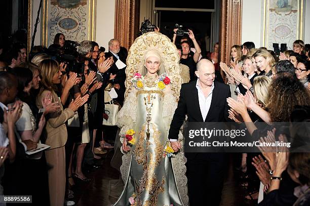 Model walks with the designer on the runway at the Christian Lacroix fashion show during Paris Fashion Week Haute Couture Autumn/Winter 2009/2010 on...