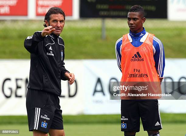 Bruno Labbadia , head coach of Hamburg talks to his player Eljero Elia during a training session at day three of the Hamburger SV training camp on...