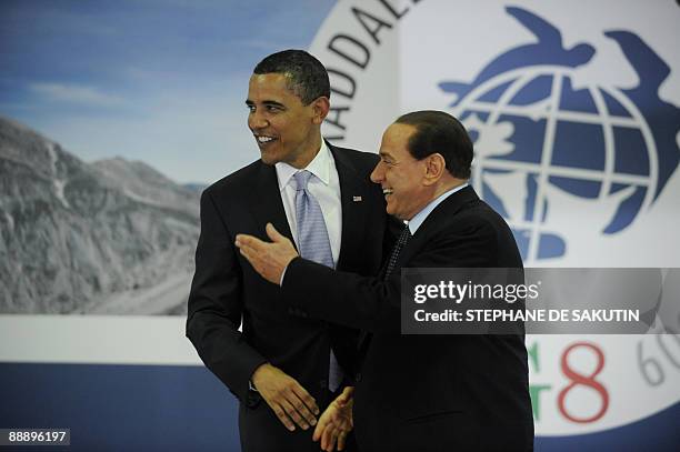 President Barack Obama and Italian Prime Minister Silvio Berlusconi greet one another on the first day of the Group of Eight summit in L'Aquila,...