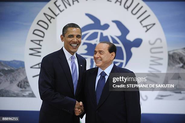 President Barack Obama and Italian Prime Minister Silvio Berlusconi greet one another on the first day of the Group of Eight summit in L'Aquila,...