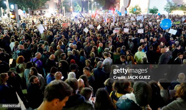 Israelis take part in a demonstration under the name "March of Shame" to protest against government corruption and Prime Minister Benjamin Netanyahu...