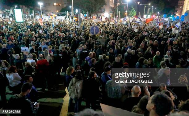 Israelis take part in a demonstration under the name "March of Shame" to protest against government corruption and Prime Minister Benjamin Netanyahu...