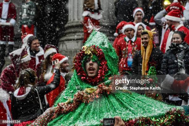 Person dressed as a Christmas tree participates in the annual bar crawl SantaCon on December 9, 2017 in New York City. The annual bar crawl of...