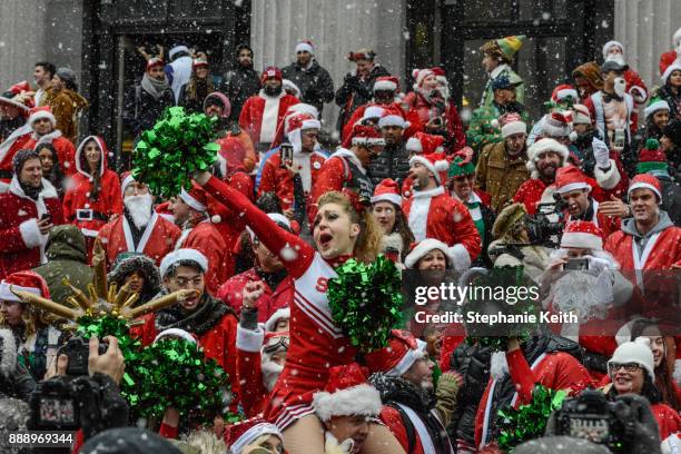 People dressed as Santa Claus participate in the annual bar crawl SantaCon on December 9, 2017 in New York City. The annual bar crawl of festive...