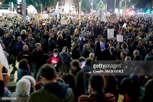 Israelis take part in a demonstration under the name "March of Shame" to protest against government corruption and Prime Minister Benjamin Netanyahu...