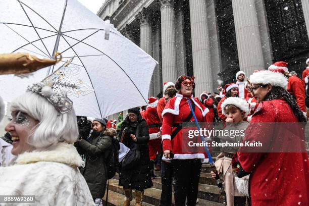 People dressed in a Santa Claus theme participate in the annual bar crawl SantaCon on December 9, 2017 in New York City. The annual bar crawl of...