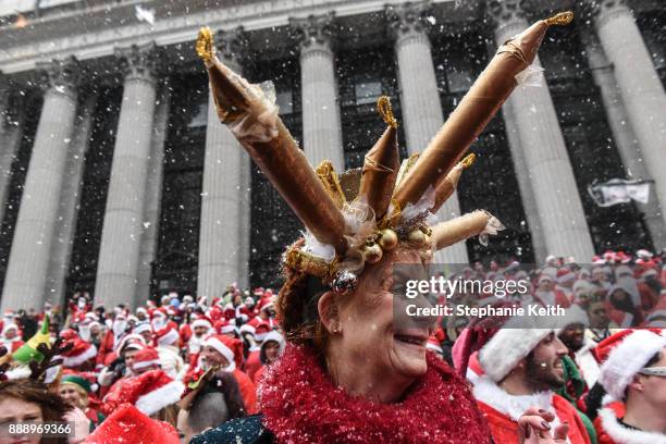 People dressed in a Santa Claus theme participate in the annual bar crawl SantaCon on December 9, 2017 in New York City. The annual bar crawl of...