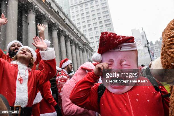 People dressed in a Santa Claus theme participate in the annual bar crawl SantaCon on December 9, 2017 in New York City. The annual bar crawl of...