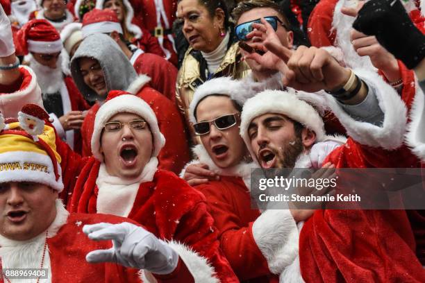 People dressed as Santa Claus participate in the annual bar crawl SantaCon on December 9, 2017 in New York City. The annual bar crawl of festive...