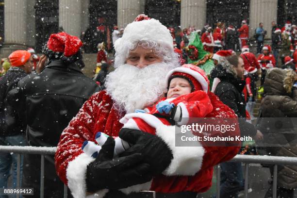 People dressed as Santa Claus participate in the annual bar crawl SantaCon on December 9, 2017 in New York City. The annual bar crawl of festive...