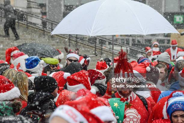 People dressed as Santa Claus participate in the annual bar crawl SantaCon on December 9, 2017 in New York City. The annual bar crawl of festive...