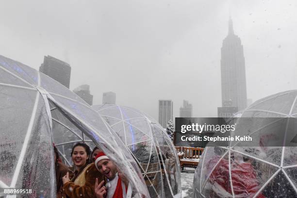 People dressed as Santa Claus participate in the annual bar crawl SantaCon on December 9, 2017 in New York City. The annual bar crawl of festive...