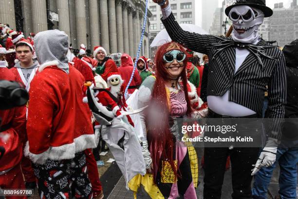 People dressed in a Santa Claus theme participate in the annual bar crawl SantaCon on December 9, 2017 in New York City. The annual bar crawl of...