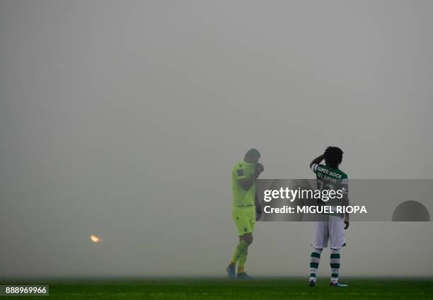 Sporting's players wait to start the match due to flares smoke during the Portuguese league football match between Boavista and Sporting Lisbon at...