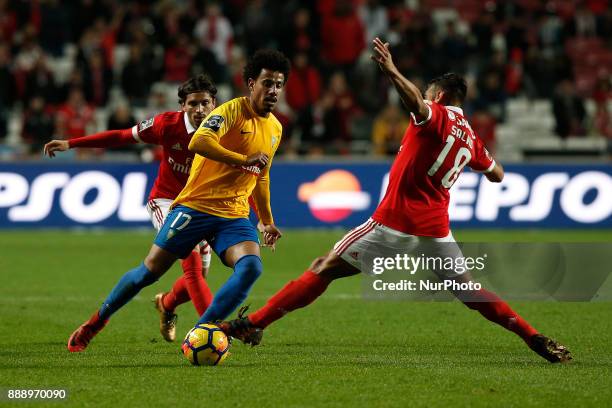 Estoril's midfielder Lucas Evangelista vies for the ball with Benfica's midfielder Filip Krovinovic and Benfica's forward Eduardo Salvio during...